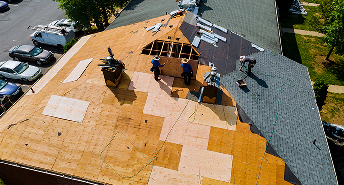 Construction worker on a renovation roof the house installed new shingles